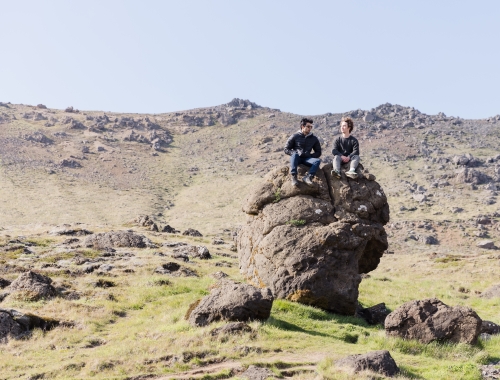 Two students sitting on a big rock in Iceland