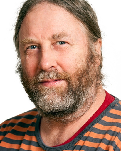 A photo of Bruce Forbes looking at the camera