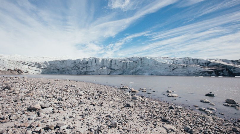 A landscape photo with a glacier in the background