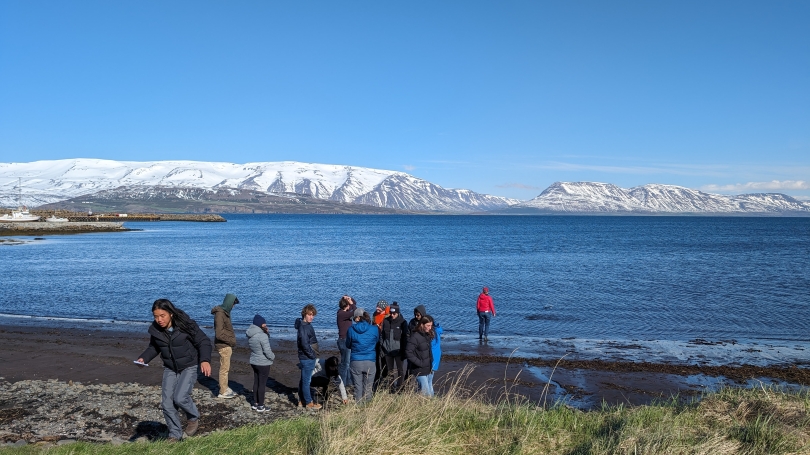 Studies standing in front of the Arctic ocean in Iceland