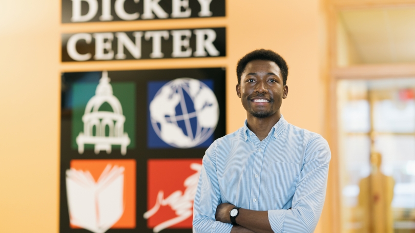 Portrait of Tinotenda Kuretu '22 in front of the Dickey Center sign