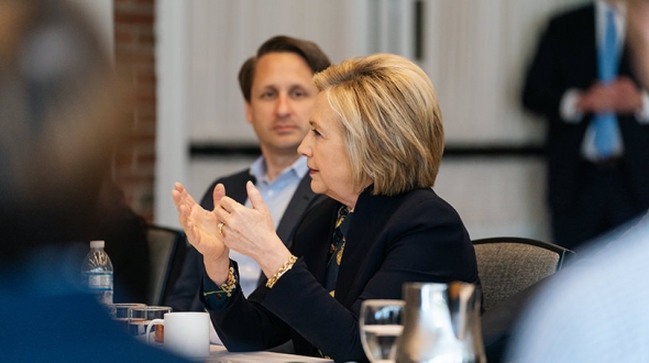 Hillary Rodham Clinton speaks with students in the Dickey Center's War and Peace Fellows program as program coordinator Benjamin Valentino listens.